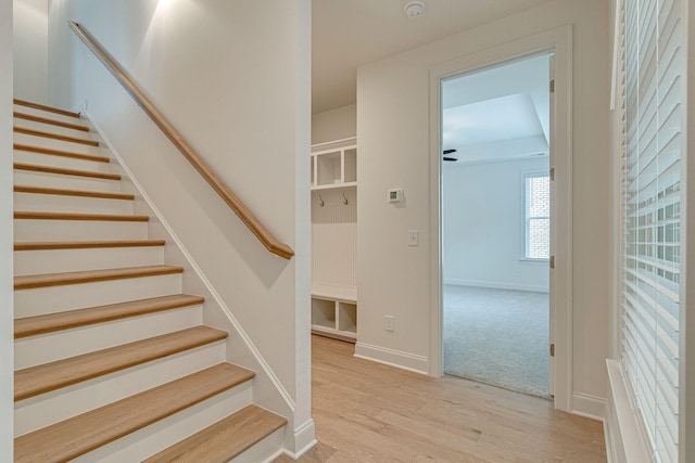 stairs featuring baseboards and wood finished floors