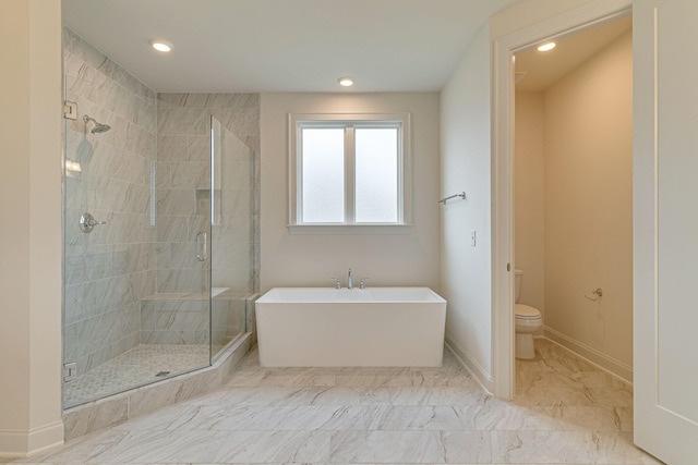 full bathroom with marble finish floor, a soaking tub, toilet, a stall shower, and baseboards