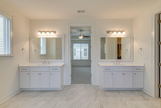 bathroom with two vanities, a sink, and visible vents