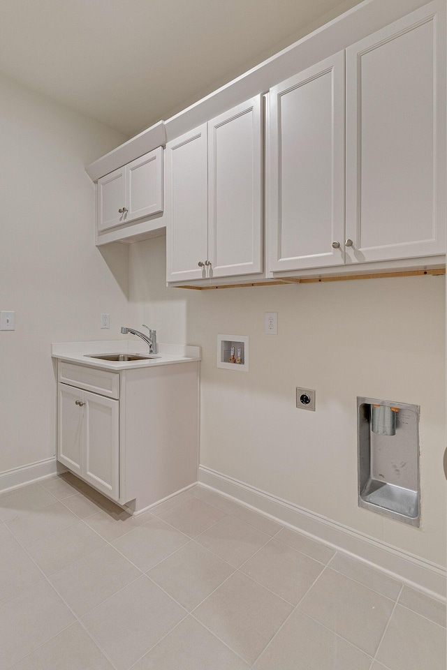 laundry room with light tile patterned floors, washer hookup, a sink, cabinet space, and electric dryer hookup