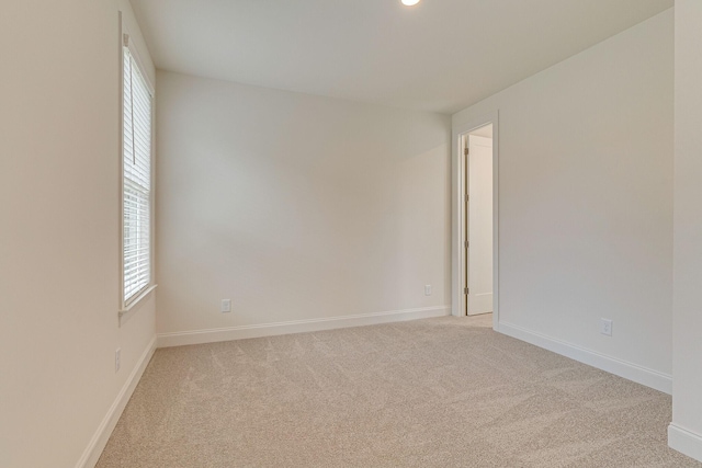 unfurnished room with recessed lighting, light colored carpet, and baseboards