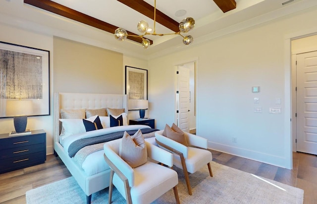 bedroom featuring light wood-style floors, a chandelier, beamed ceiling, and baseboards