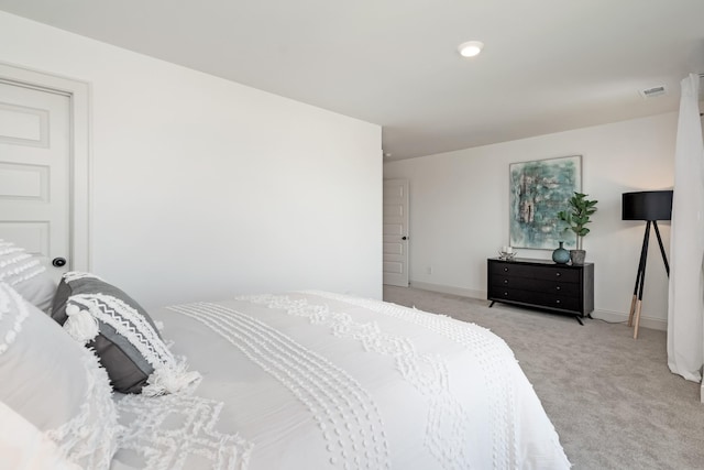 bedroom with light colored carpet, visible vents, and baseboards