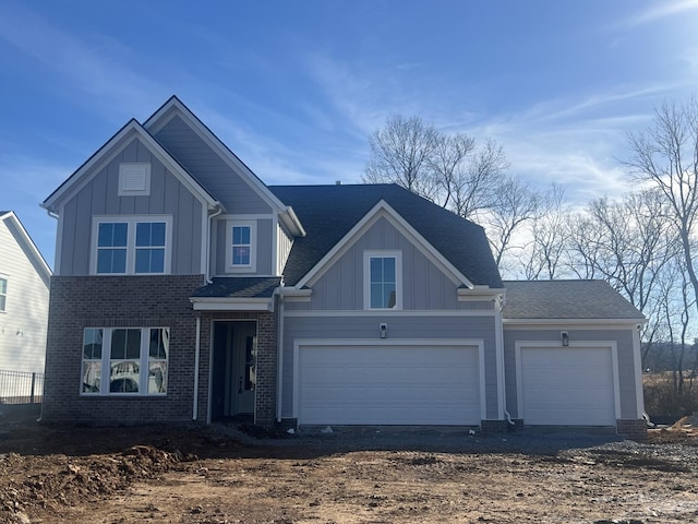 view of front of home featuring dirt driveway, brick siding, board and batten siding, and a garage