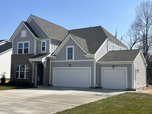 view of front of home with board and batten siding, driveway, and roof with shingles