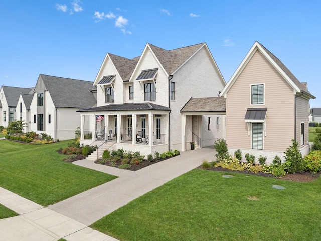 modern inspired farmhouse featuring a standing seam roof, metal roof, a front lawn, and covered porch