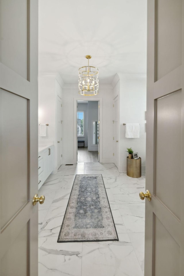 6324 Percheron Ln, Arrington, TN 37014 - interior space featuring marble finish floor, baseboards, ornamental molding, and an inviting chandelier