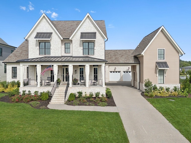 modern farmhouse style home featuring covered porch, brick siding, concrete driveway, a front lawn, and a standing seam roof