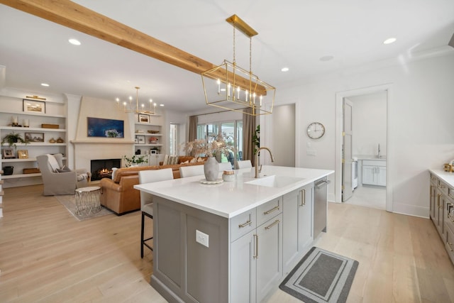 6324 Percheron Ln, Arrington, TN 37014 - kitchen featuring light wood-type flooring, a fireplace, a breakfast bar area, and a sink