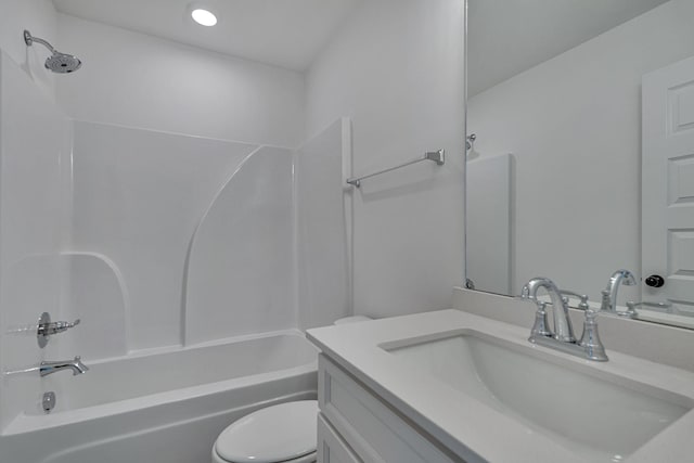 bathroom featuring toilet, vanity, and  shower combination