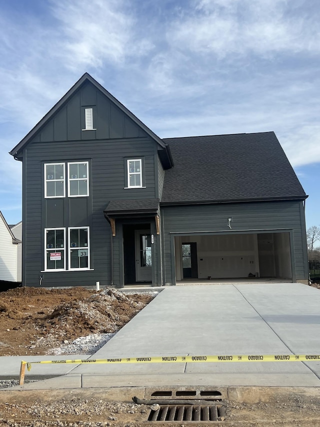 view of front of house featuring an attached garage, board and batten siding, and driveway