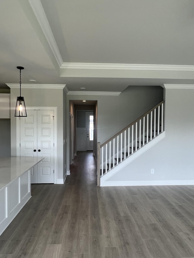 interior space featuring dark wood finished floors, stairway, crown molding, and baseboards