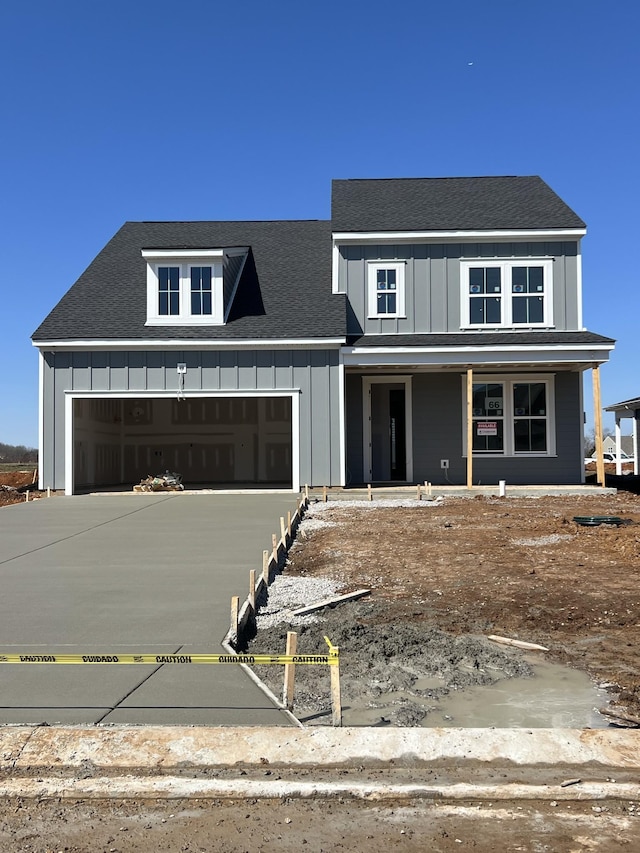 view of front of home featuring board and batten siding, a shingled roof, concrete driveway, covered porch, and a garage