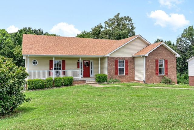 single story home with a porch, brick siding, a shingled roof, and a front lawn