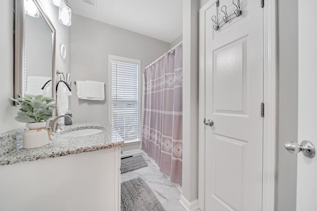 bathroom featuring marble finish floor, visible vents, vanity, and baseboards