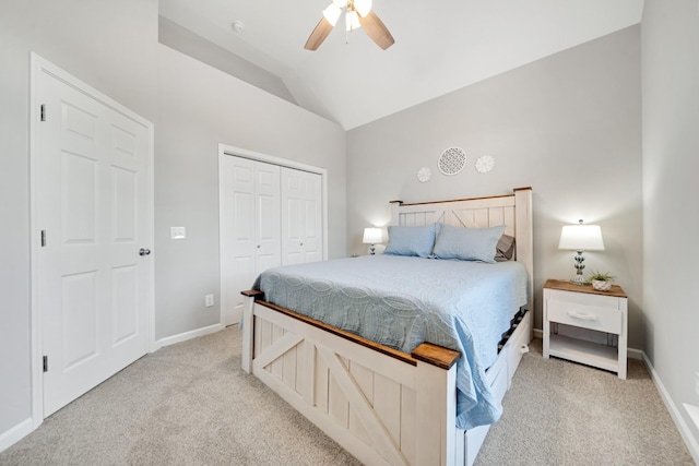 bedroom featuring lofted ceiling, a closet, light carpet, and baseboards