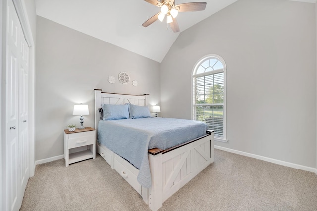 bedroom with lofted ceiling, ceiling fan, baseboards, and light colored carpet