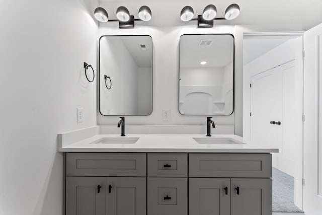 full bath featuring visible vents, a sink, and double vanity