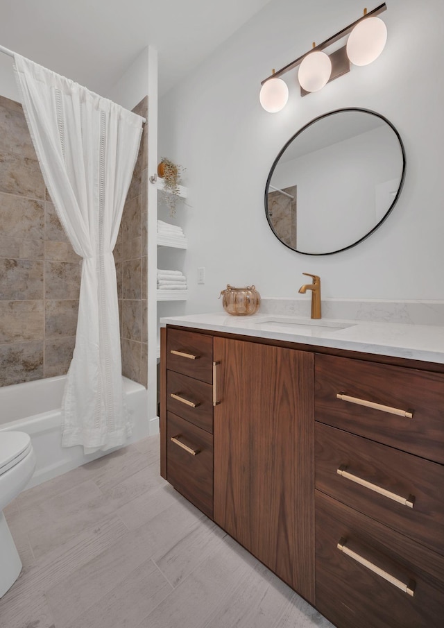 bathroom featuring shower / bath combo, vanity, and toilet