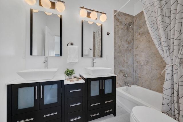 full bathroom featuring double vanity, a sink, toilet, and shower / bath combo with shower curtain