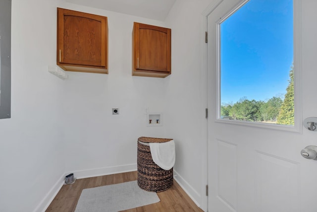 laundry area with washer hookup, cabinet space, hookup for an electric dryer, wood finished floors, and baseboards