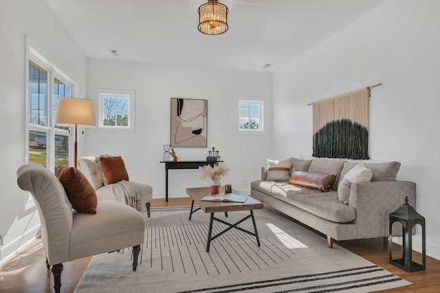 living room with visible vents, plenty of natural light, and wood finished floors