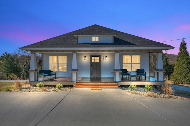 bungalow featuring a shingled roof and a porch