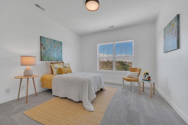 carpeted bedroom featuring visible vents and baseboards