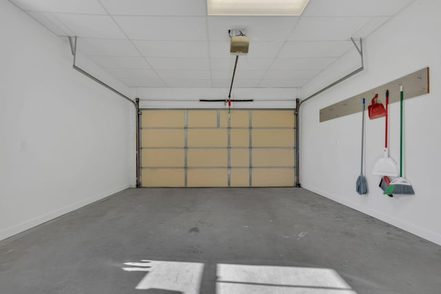 garage with baseboards and a garage door opener