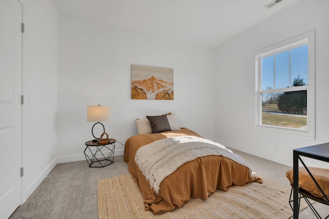 bedroom with light carpet, visible vents, and baseboards