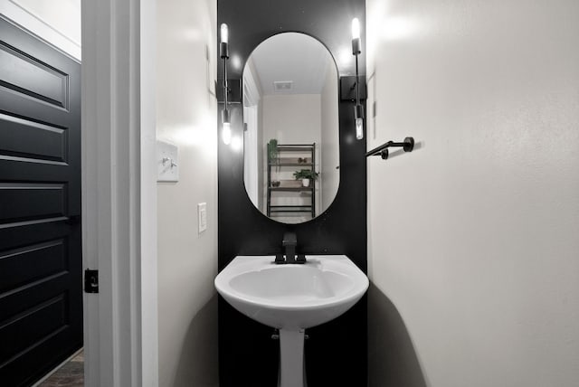 bathroom featuring visible vents and a sink