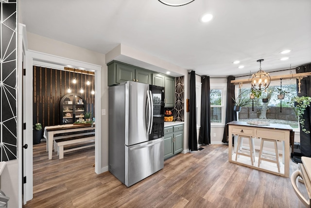 kitchen with recessed lighting, light countertops, smart refrigerator, wood finished floors, and green cabinetry