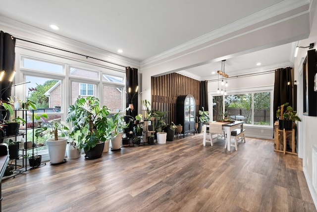 interior space with a notable chandelier, ornamental molding, wood finished floors, and recessed lighting