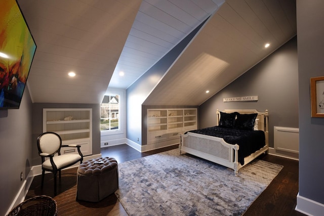 bedroom featuring vaulted ceiling, baseboards, and wood finished floors