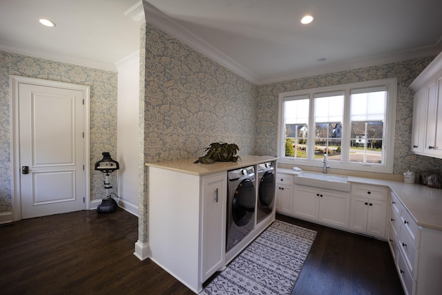 kitchen featuring crown molding, dark wood finished floors, light countertops, a sink, and separate washer and dryer