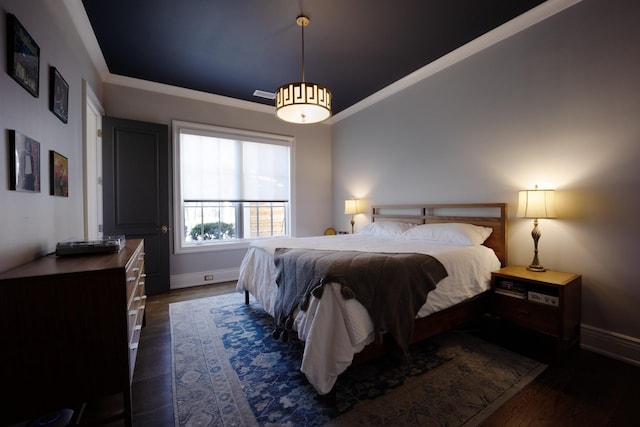 bedroom with crown molding, baseboards, and dark wood-type flooring