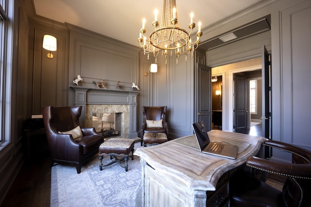 interior space with a fireplace, a decorative wall, and a notable chandelier