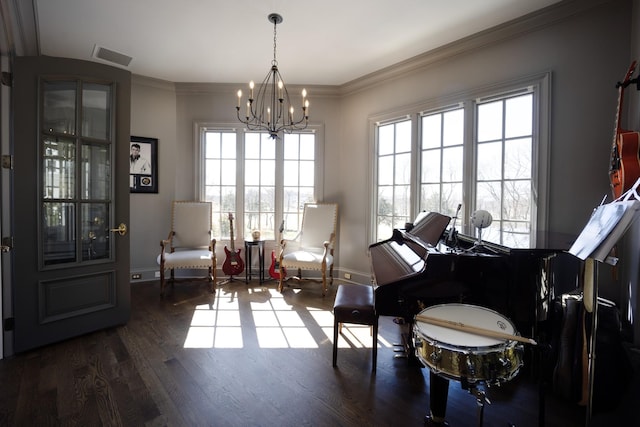 sitting room with baseboards, visible vents, ornamental molding, and wood finished floors