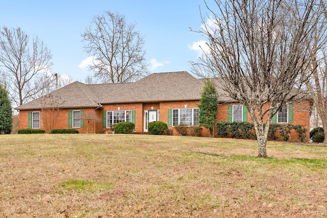 single story home with a front yard, brick siding, and a shingled roof