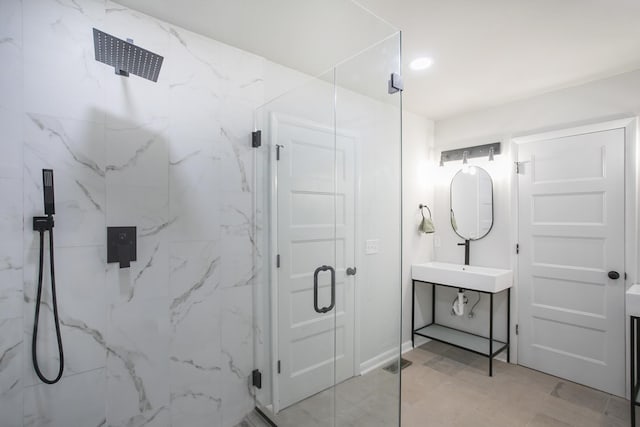 bathroom with recessed lighting, visible vents, a sink, and a marble finish shower