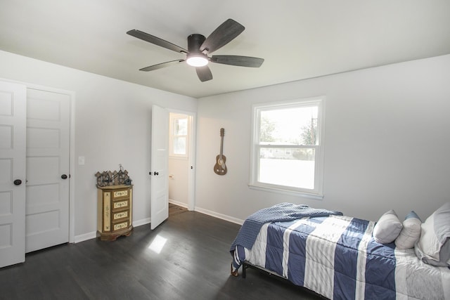 bedroom with ceiling fan, baseboards, and dark wood finished floors