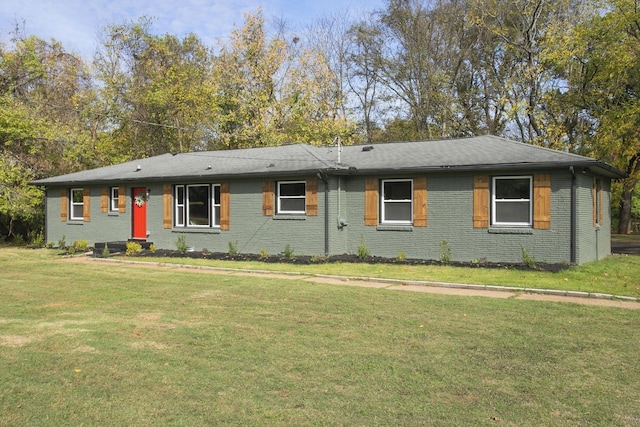 ranch-style home with a front yard and brick siding