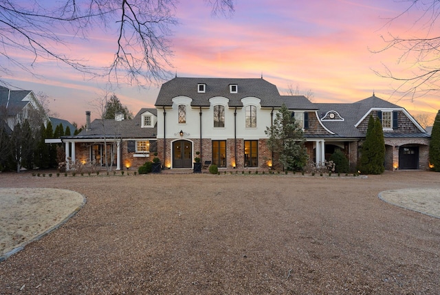 french country inspired facade with brick siding