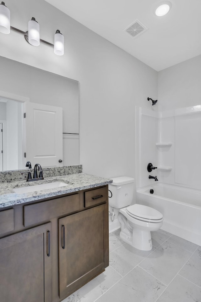 full bathroom with visible vents, toilet, marble finish floor, vanity, and shower / washtub combination