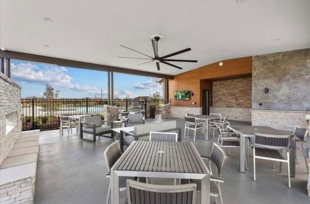 view of patio with outdoor dining area, ceiling fan, and an outdoor living space