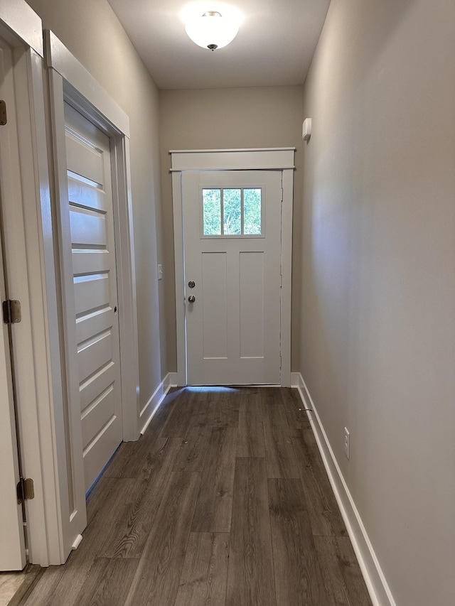 entryway with dark wood-style floors and baseboards