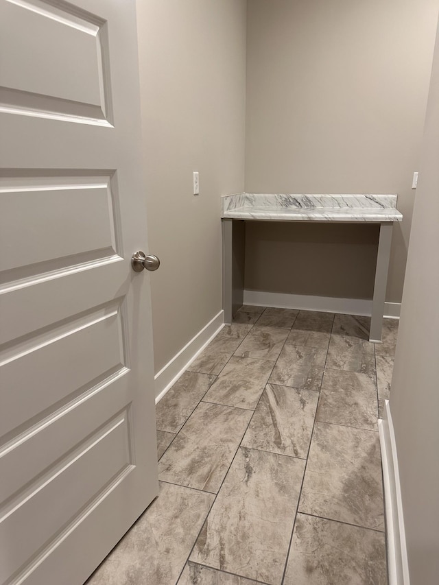 washroom featuring baseboards