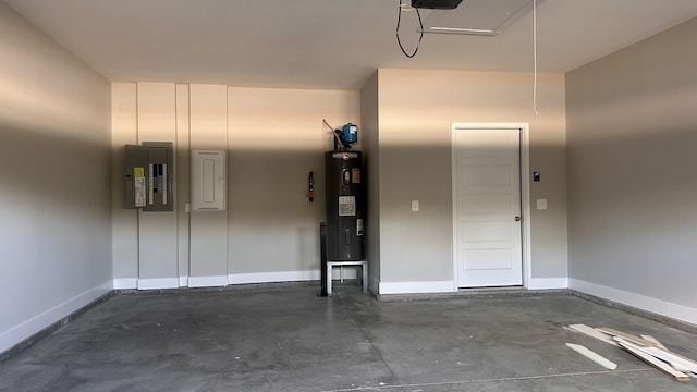 garage with electric panel, baseboards, and electric water heater