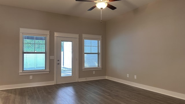 entryway featuring dark wood-type flooring, ceiling fan, and baseboards