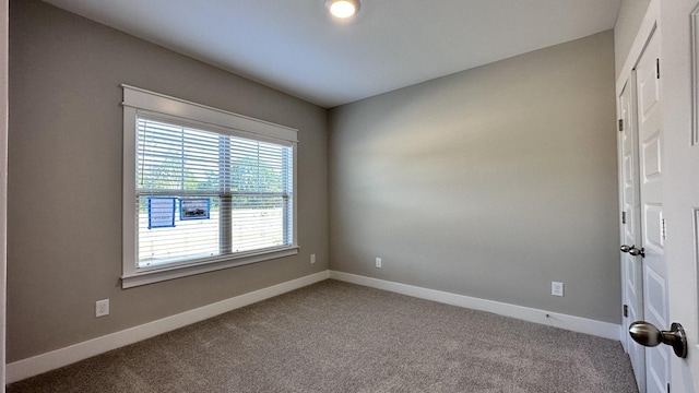 spare room with carpet floors and baseboards